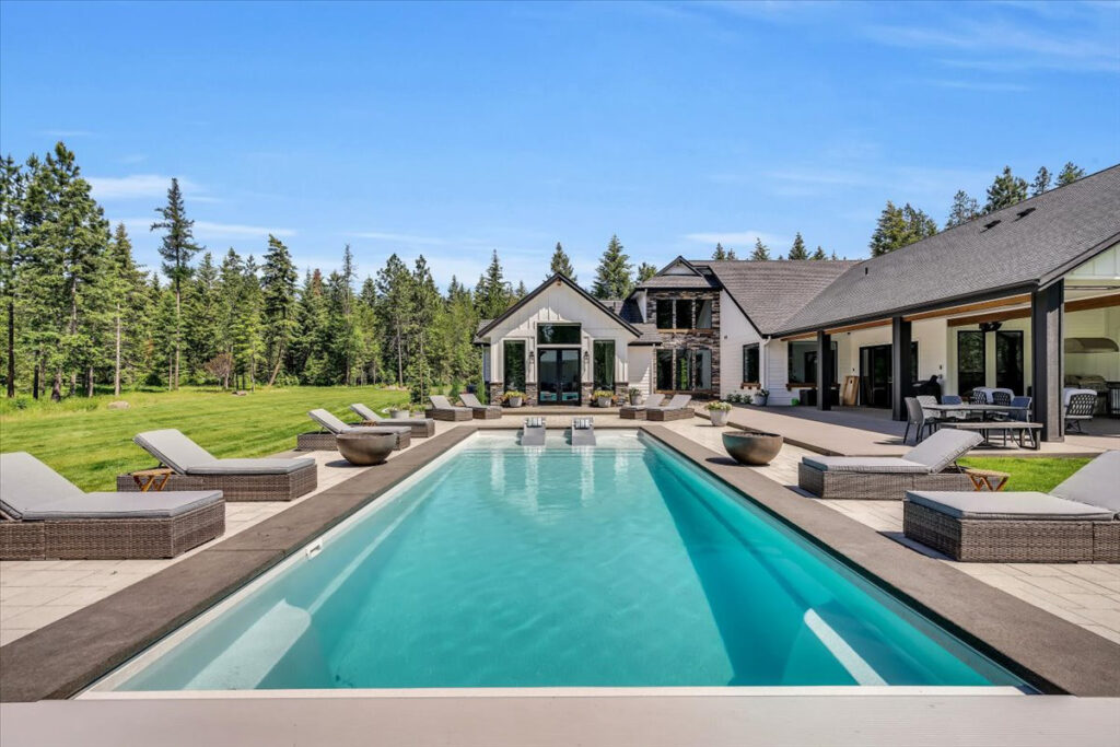 Backyard fiberglass pool with outdoor living upgrades in Spokane and North Idaho