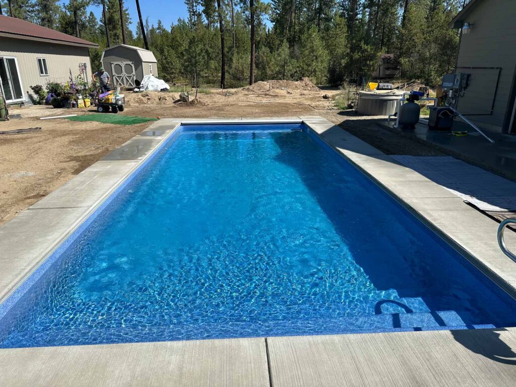 Fiberglass pool installation in Spokane backyard by Water Magic Pools & Spa