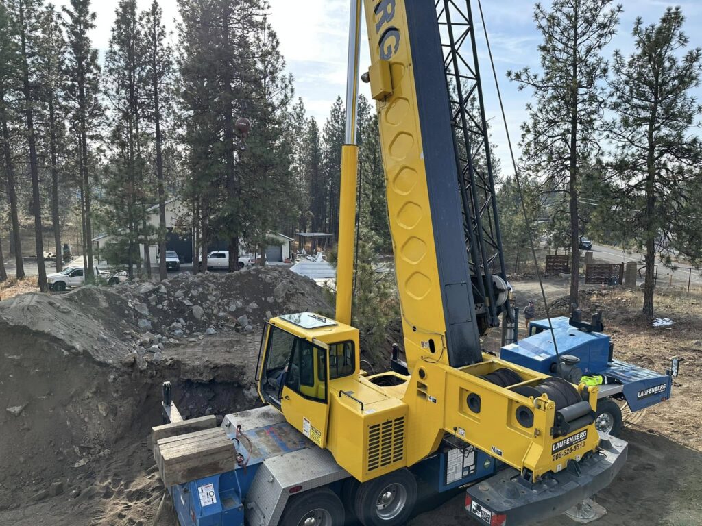 Fiberglass pool installation in a sloped Spokane backyard